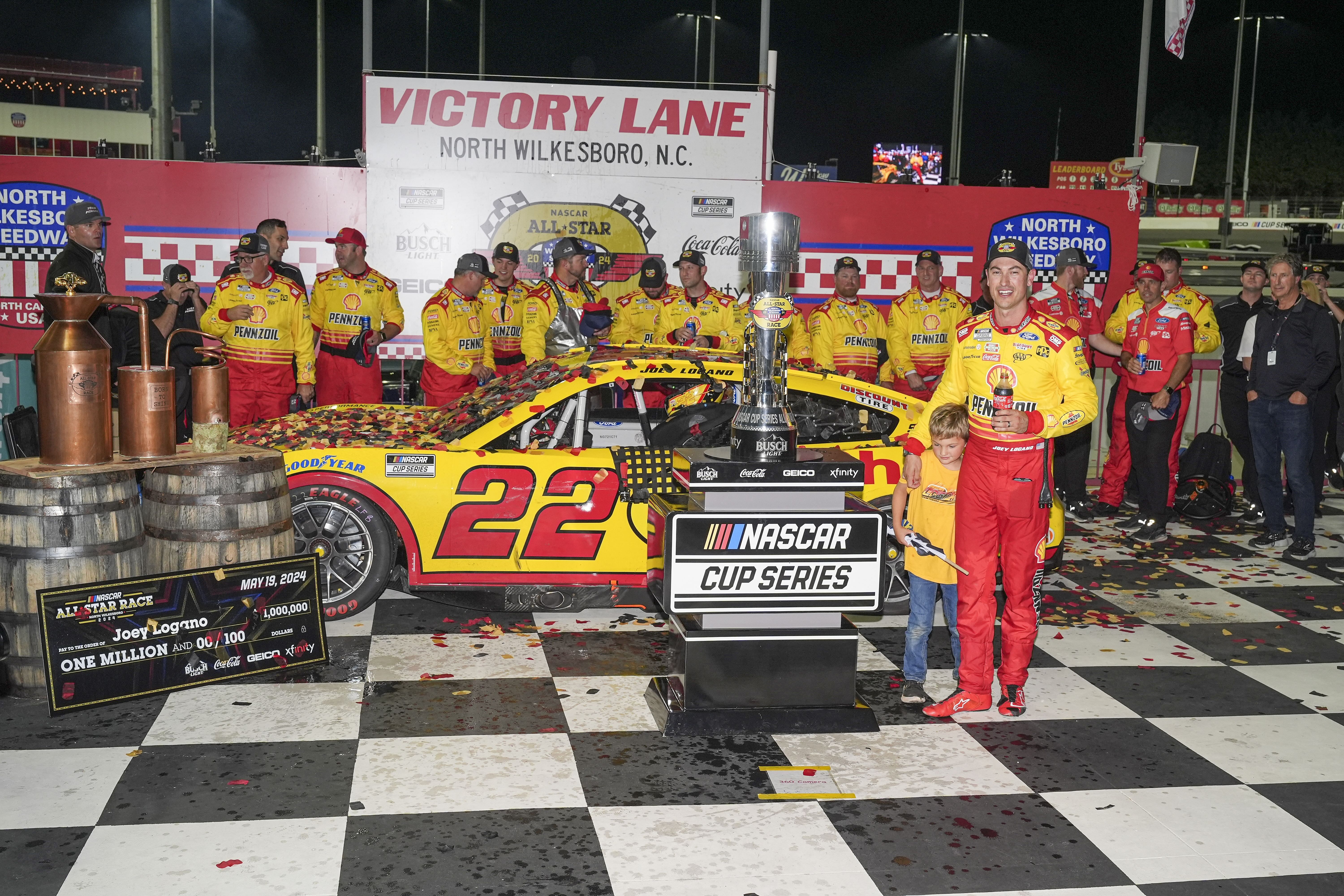 Joey Logano (22) celebrates his win with his team during the All-Star race at North Wilkesboro Speedway. - Source: Imagn